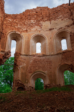A ruined brick wall with crumbling plaster. An old abandoned church. Inside view. Russia, Smolensk region, 1753.