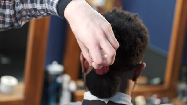 Barber using cleaninf brush in a salon