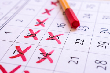Red cross marked with red marker on calendar