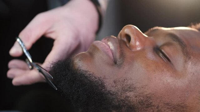 African American client having haircut at barber's