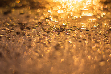 yellow and white bokeh background. Rainy streets at night are reflected lights