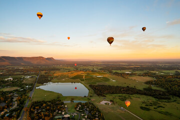 Hot air Balloons in Pokolbin wine region over wineries and vineyards, Aerial image, Hunter Valley, NSW, Australia