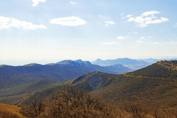 Mountains landscape against blue sky with clouds on sunny day