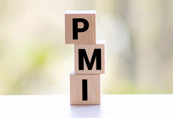 PMI - acronym from wooden blocks with letters, abbreviation PMI Private Mortgage Insurance.