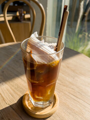 A glass of iced americano with coconut juice