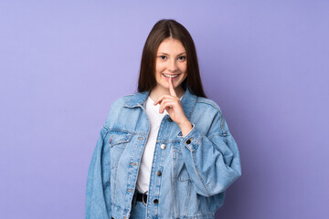 Teenager caucasian girl isolated on purple background showing a sign of silence gesture putting finger in mouth