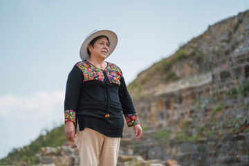 Woman in ethnic traditional Mexican dress. Pyramids background for Mexico.