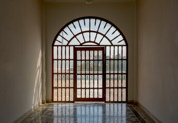 Beautiful turned wooden door with a large arch.