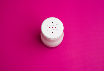 salt or pepper shaker from the top point of view. seasoning powder container in white. food...