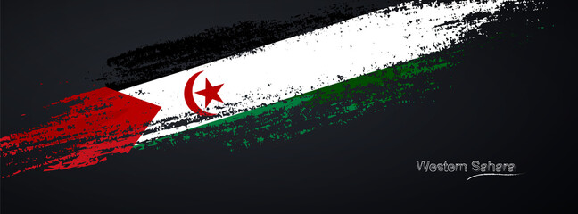 Grunge brush of Western Sahara flag on shiny black background. Creative glitter sparkle brush paint vector illustration