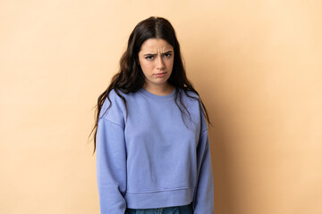 Fototapeta premium Young caucasian woman over isolated background with sad expression