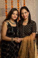 Two Indian women standing together on occasion of festival. Culture and tradition. Diwali and holi celebrations