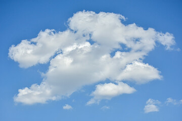 Naklejka na ściany i meble Beautiful cumulus clouds against the blue daytime sky.