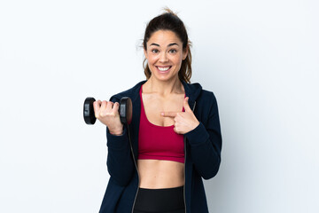 Sport woman making weightlifting over isolated white background with surprise facial expression