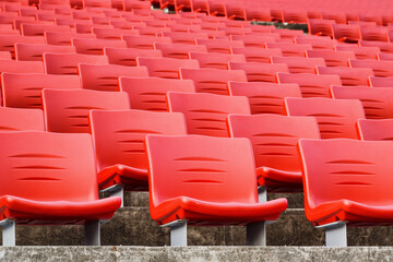 Obraz premium Rows of empty seats in a stadium. Red plastic seats