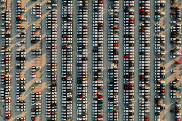 Fototapeta na wymiar Aerial view new cars lined up in the parking station for import and export business logistic to dealership for sale, Automobile and automotive car parking lot for commercial business industry.