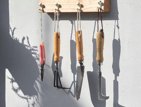 Gardening tools hanging on a rope