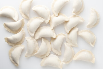 Fototapeta na wymiar Frozen dumplings on a white background, top view