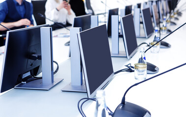 Desktop computers stand in a row on a desk in the office.