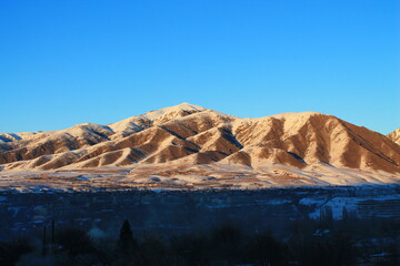 sunset mountain with snow and blue sky