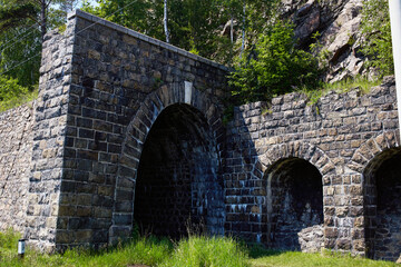 Fototapeta na wymiar Italian wall and tunnel on the coast of Lake Baikal. Circum-Baikal railroad on summer. 