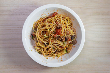 A bowl of spaghetti with tomato based sauce.