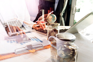 businessman holding coins putting in glass and using calculator. concept saving money and finance accounting.