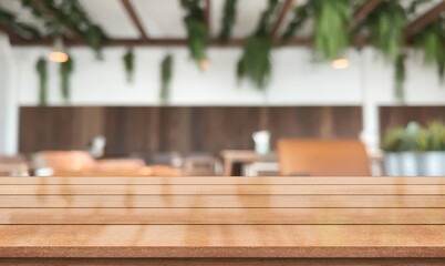 Empty wooden table top with lights bokeh on blur restaurant background.