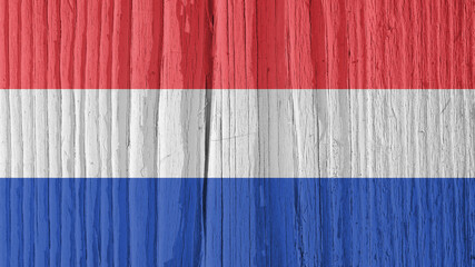 The flag of the Netherlands on dry wooden surface, cracked with age. Background, wallpaper or backdrop with Dutch national symbol. Old wood. Hard sunlight with shadows