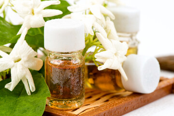 Fresh jasmine flowers and perfume isolated on white background.