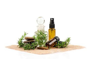 Fresh rosemary flowers ,green leaves and extracted in the bottle isolated on white background.