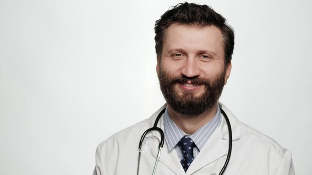 Portrait of smiling doctor on white background