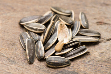 Dried sunflower seeds on an old wood background.