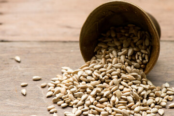 Dried sunflower seeds on an old wood background.