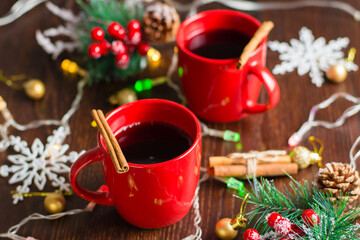 Delicious mulled wine with cinnamon in red cups. Christmas anticipation concept, top and side view