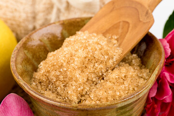 Scrub skin with lemon and red sugar isolated on white background.