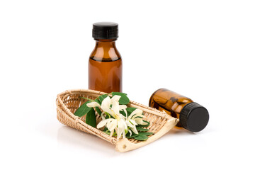 Moringa flowers ,green leaves and extracted in the bottle isolated on white background.