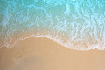 Fototapeta na wymiar Soft ocean wave on sandy beach.