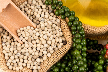 Fresh,black, white pepper and oil isolated on white background.
