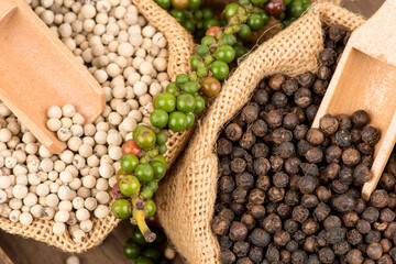 Fresh,black and white pepper isolated on white background.