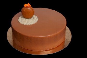 layered cocoa cake on black background with macaron