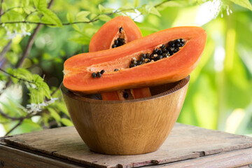 Papaya fruits and seeds on nature background.