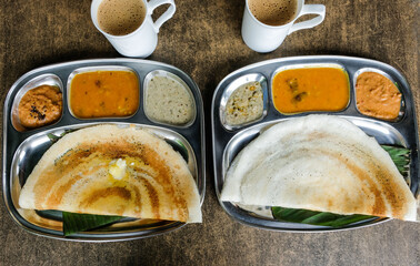 Popular Southern Indian Cuisine / Butter and Plain Dosa with Masala Tea / Delicious thin and crispy crepe-like pancake goes well with various chutnies, igli podi and ever popular masala tea