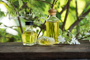 Wrightia religiosa flowers and essential oil on nature background.