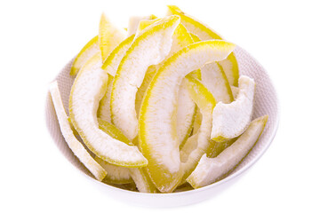 Pomelo slices in a light plate on a white background.