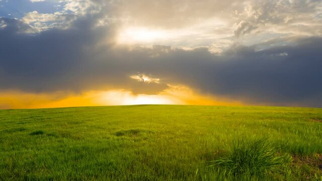 green prairie at the dramatic sunset, countryside rural  time lapse scene