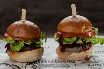 Two mini beef burgers with beetroot relish. Beef patties on two brioche buns with lettuce and beetroot
