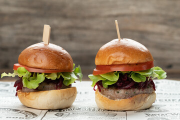 Two mini beef burgers with beetroot relish. Beef patties on two brioche buns with lettuce and beetroot - obrazy, fototapety, plakaty