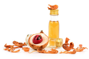 Fresh nutmeg ,dried mace and oil isolated on white background.