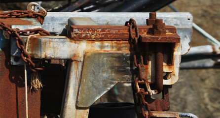close up detail on a heavy metal tool. Rust, silver, chains, screws, Sisimiut, Greenland
